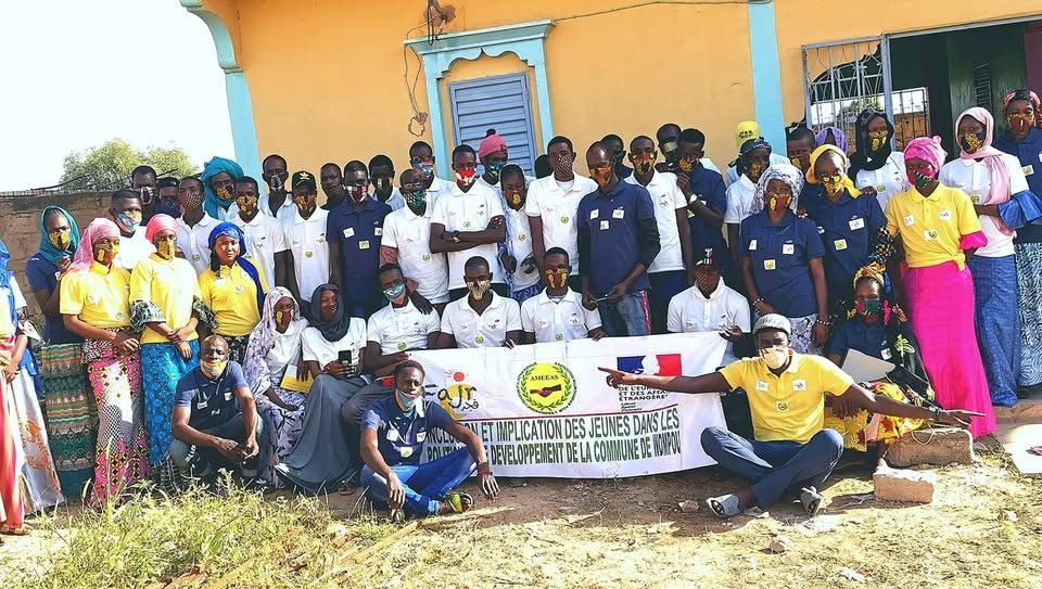Jeunes et équipe AMEEAS réunis devant une banderole sur l'implication des jeunes dans les politiques de développement de la commune de Nimpou
